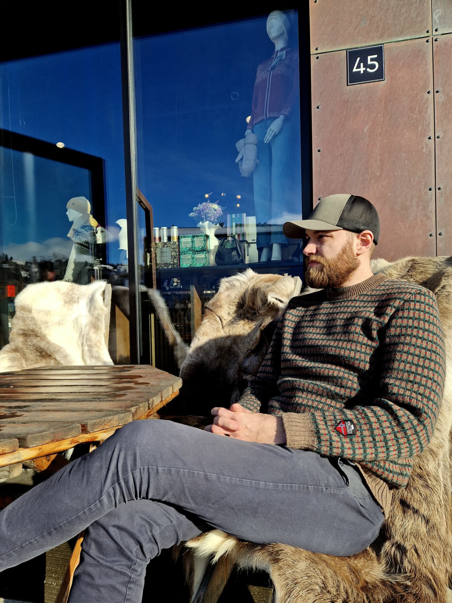Remy Traasdahl wearing a cap, seated outside The Gift Box at Vervet