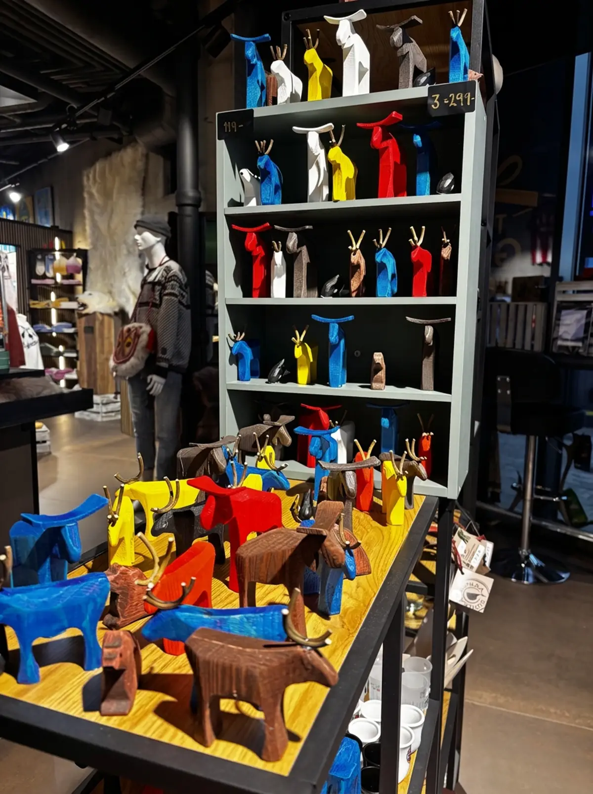 Colourful handmade wooden figures displayed at The Gift Box