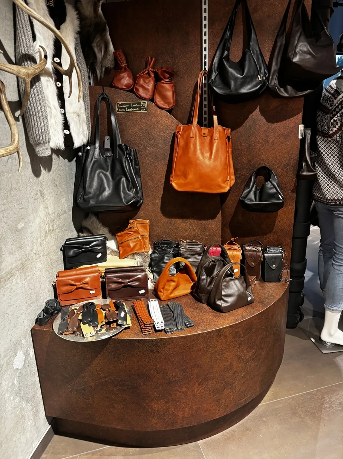 Display of handmade leather bags and accessories in the shop